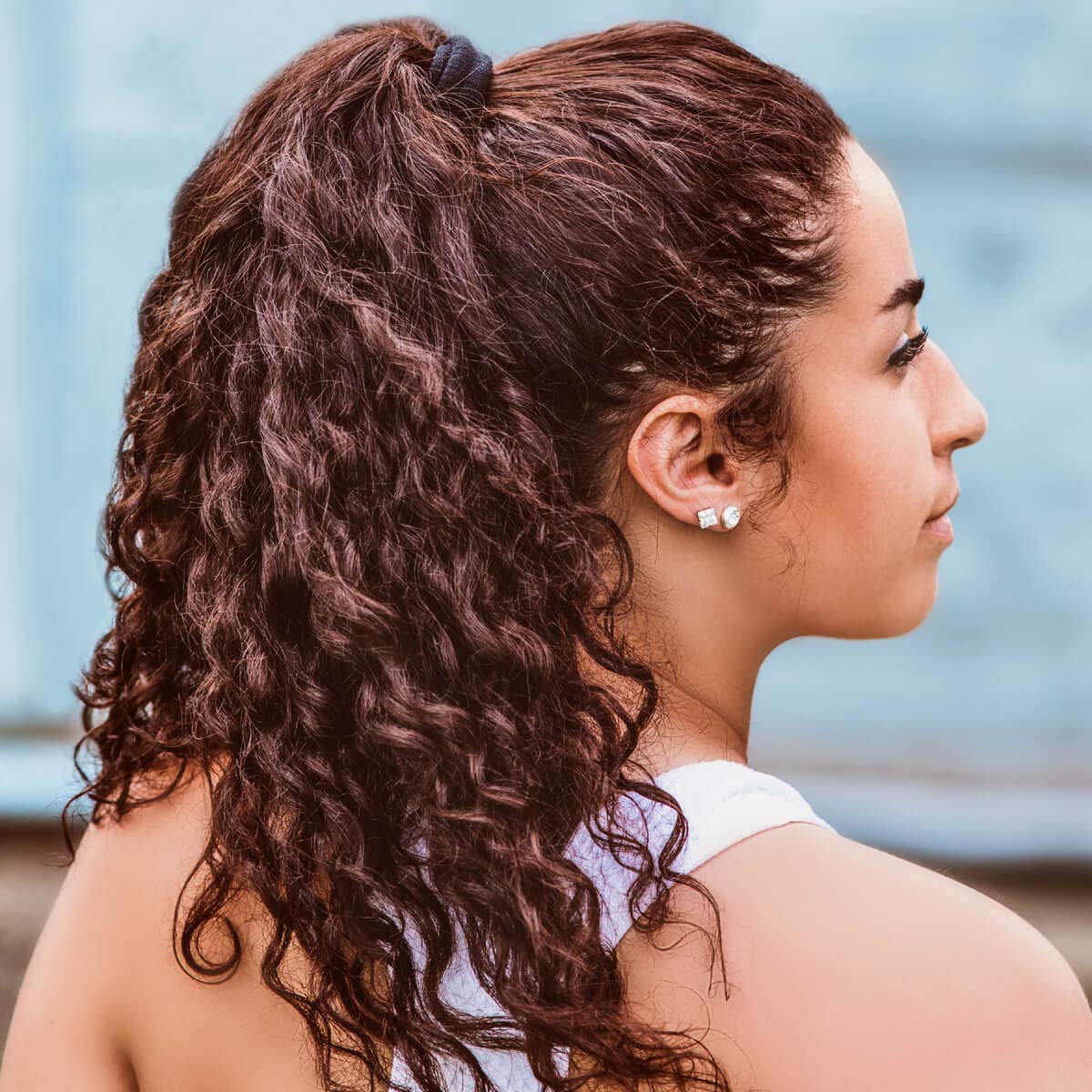 Burlybands wrapped around a thick ponytail demonstrating secure hold for voluminous hair