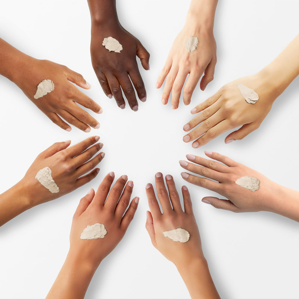 Burt's Bees cream applied on hand demonstrating blendable coverage benefit