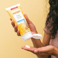 Burt's Bees bottle held by hand to show 6 oz scale