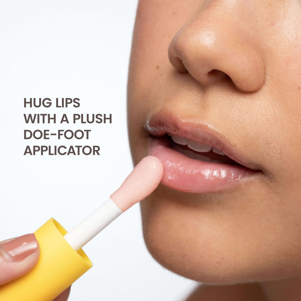 Burt's Bees lip oil in hand for size comparison, portable and travel-friendly convenience