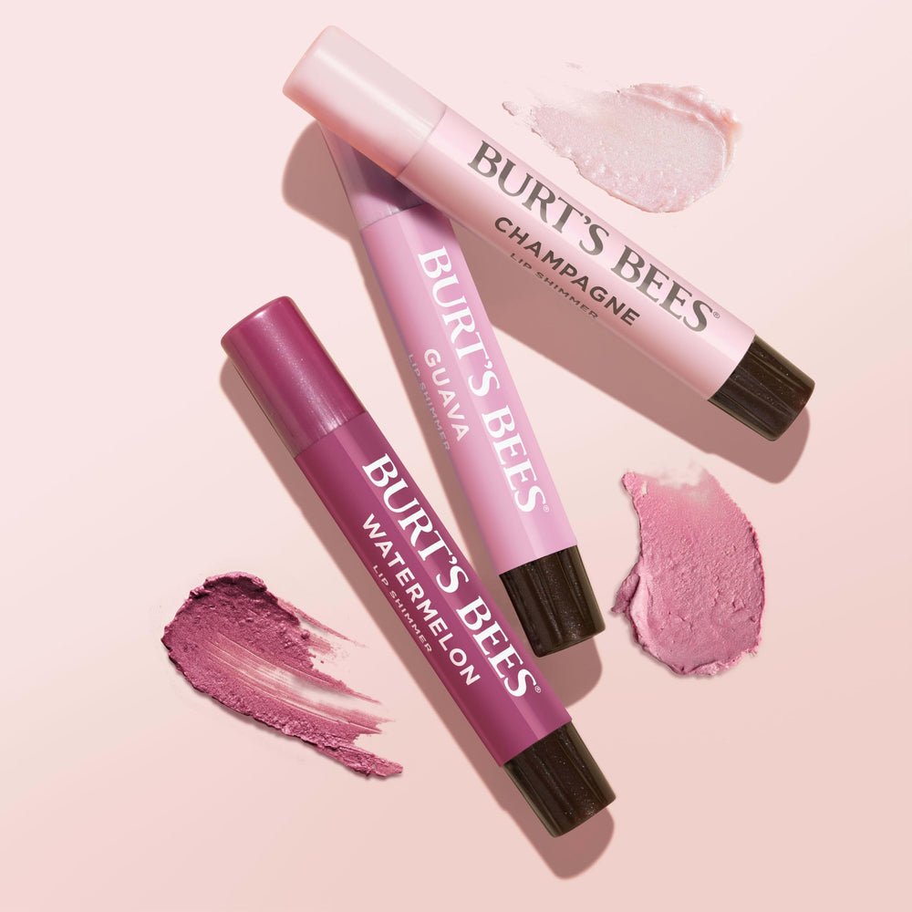 Burt's Bees lifestyle shot outdoors with a person applying balm for everyday glow