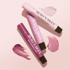 Burt's Bees lifestyle shot outdoors with a person applying balm for everyday glow