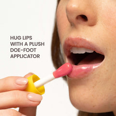 Burt's Bees lip oil held in hand illustrating compact travel-friendly size