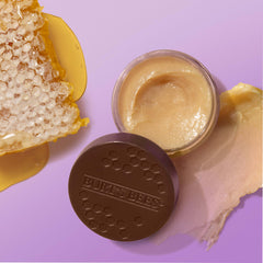 Burt's Bees jar next to coin scale displaying compact 0.25 oz travel-friendly size