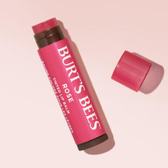 Burt's Bees balm tucked in purse with everyday items illustrating on-the-go use