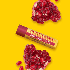 Burt's Bees tube next to coin to show compact travel-friendly size