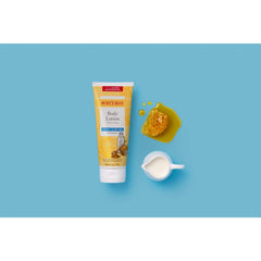 Burt's Bees dispensing lotion from nozzle for controlled amount