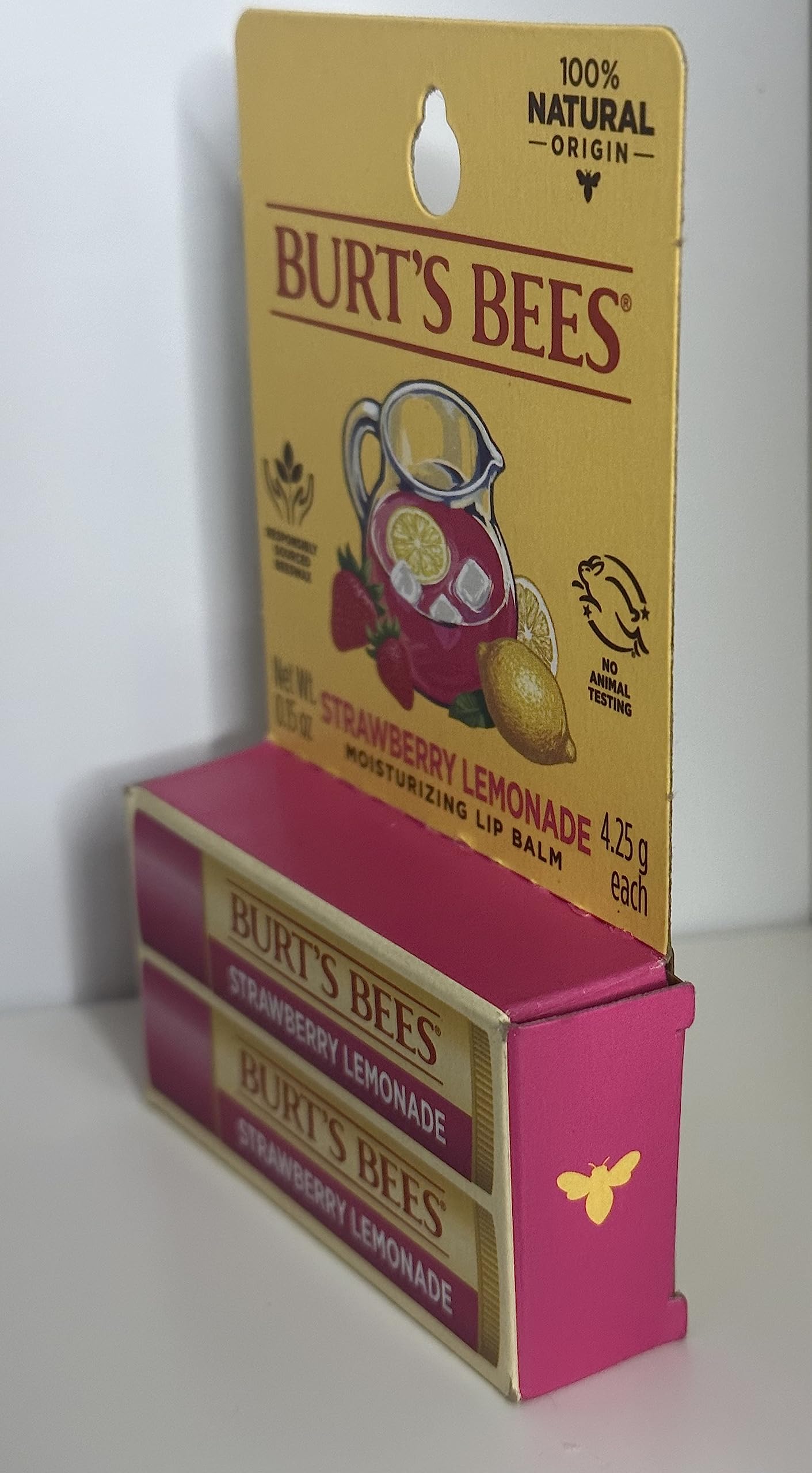 Burt's Bees beeswax and fruit pieces representing natural ingredients for moisturizing