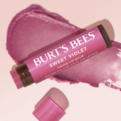 Burt's Bees balm beside a coin to show 0.15 oz size, compact and portable