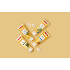 Burt's Bees lotion texture dispensed on hand, shows creamy quick-absorbing finish