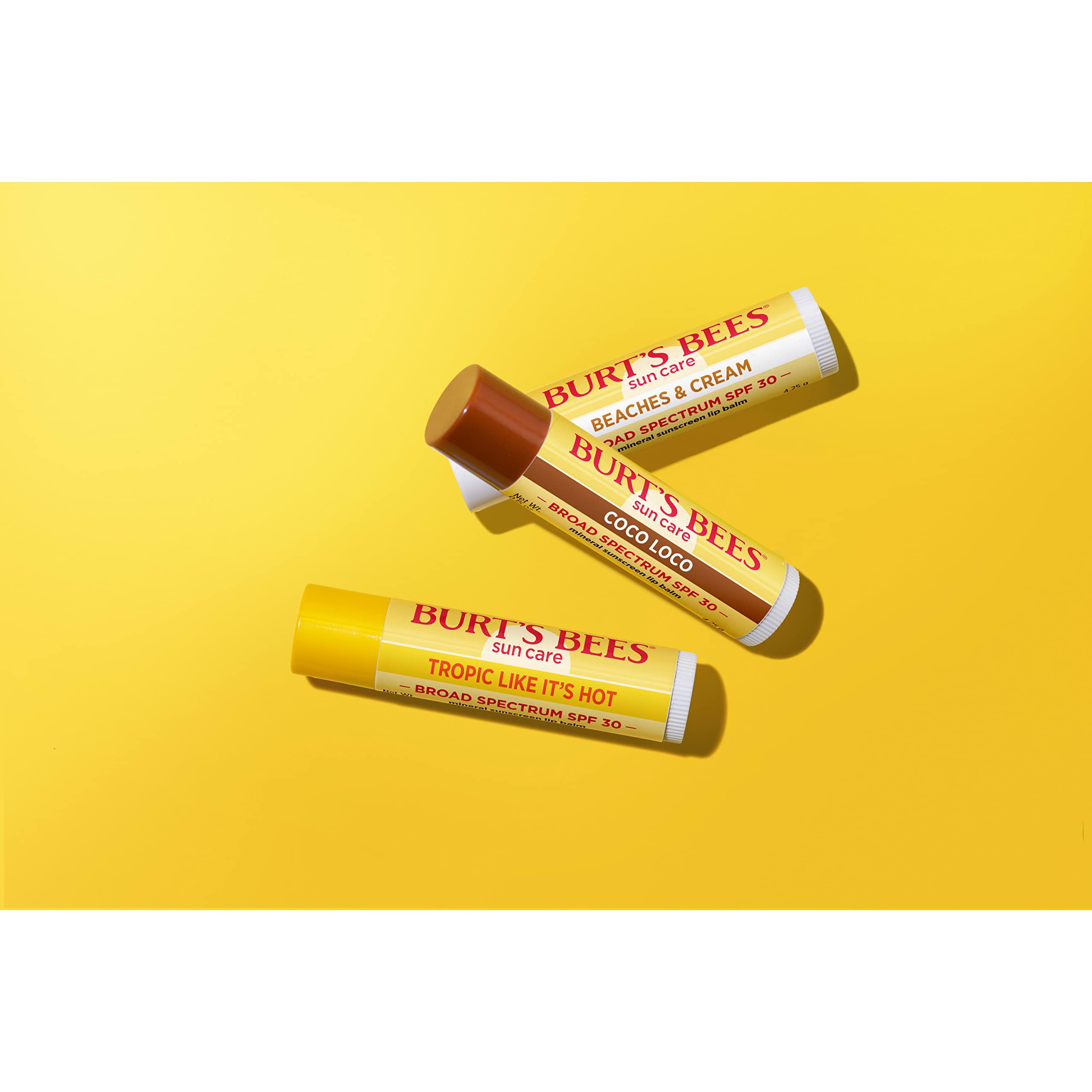 Burt's Bees tubes with caps off showing product solid stick and easy coverage benefit
