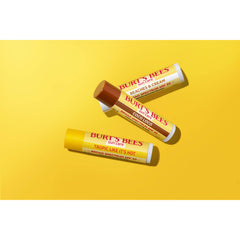 Burt's Bees tubes with caps off showing product solid stick and easy coverage benefit