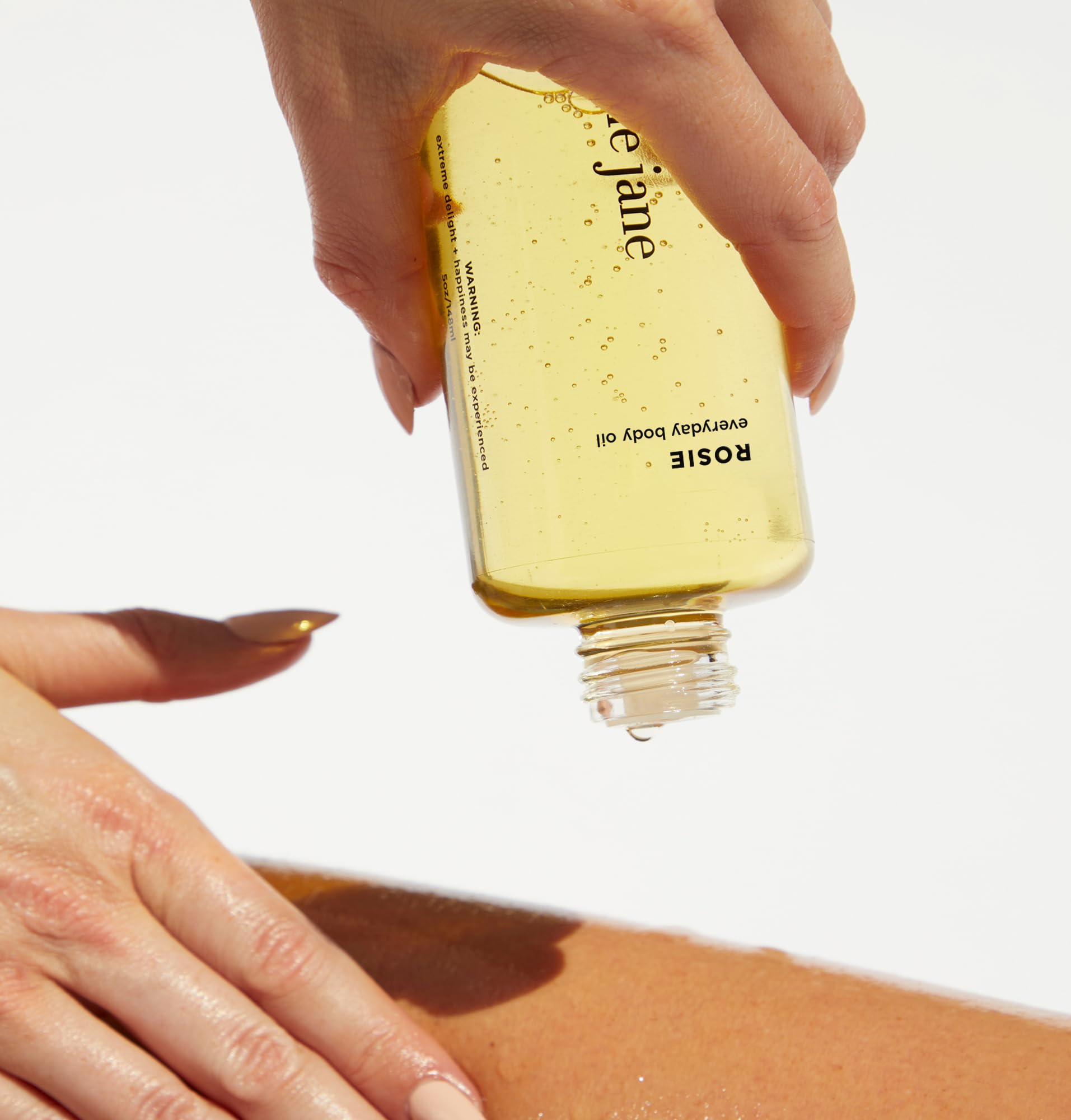 By Rosie Jane oil pouring close-up showing silky texture and absorption benefit