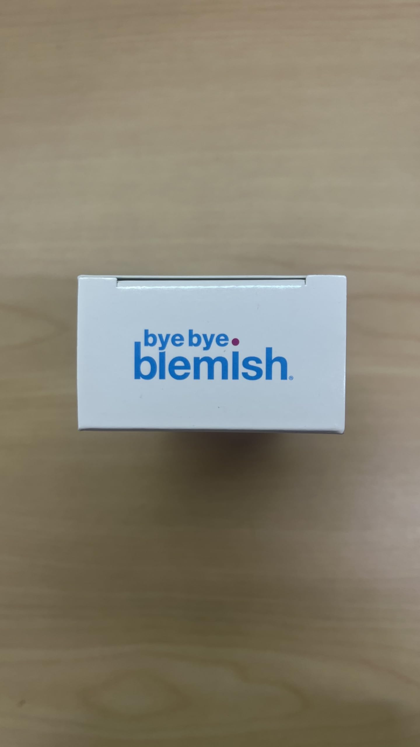 Bye Bye Blemish on a nightstand beside pillow to show evening routine placement and ease-of-use benefit