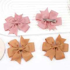 CÉLLOT children wearing bows outdoors showing playful look and reliable fit