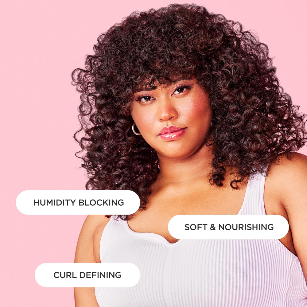 Cake Beauty hand applying curl jelly to damp hair demonstrating easy distribution and shine