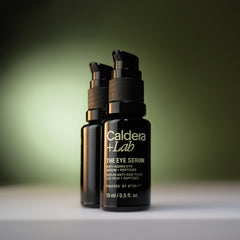Caldera + Lab bottle next to coin showing compact size for grooming routines