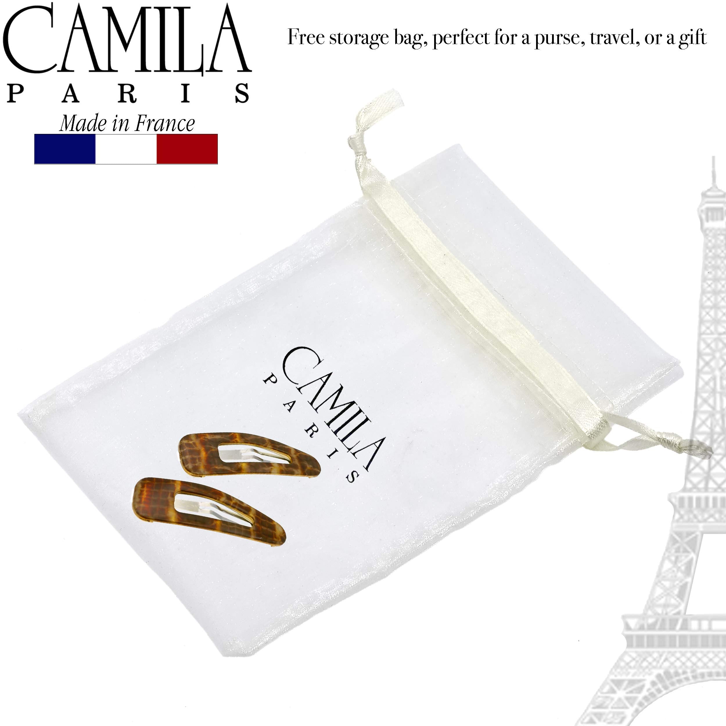 Camila size comparison next to coin to show compact 2-inch scale