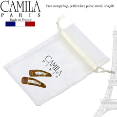 Camila size comparison next to coin to show compact 2-inch scale