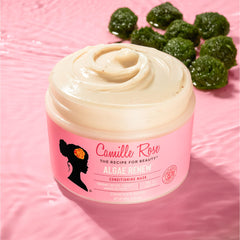 Camille Rose applying mask to textured hair demonstrating improved detangling