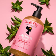 Camille Rose product in hand being applied to wet hair to demonstrate easy distribution