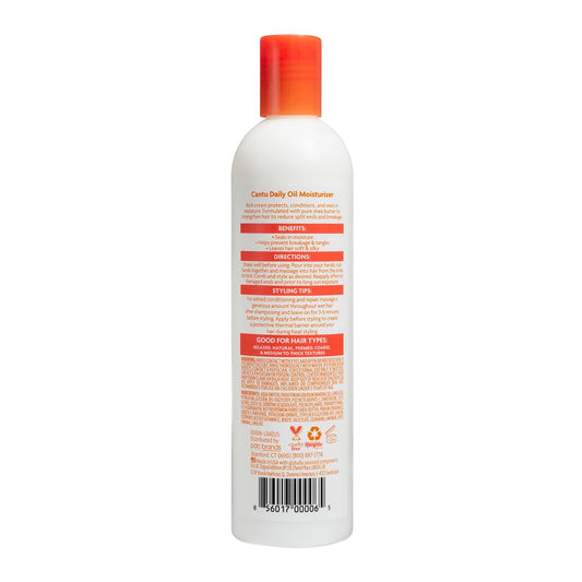 Cantu daily oil moisturizer pump application on hands demonstrating controlled dispense and smooth finish