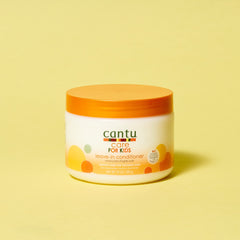 Child having hair detangled with Cantu leave-in conditioner for gentler comb-through