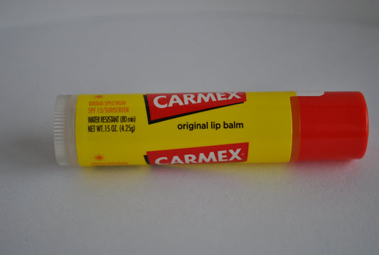Carmex jar in-hand application demonstrating smooth texture and quick soothing