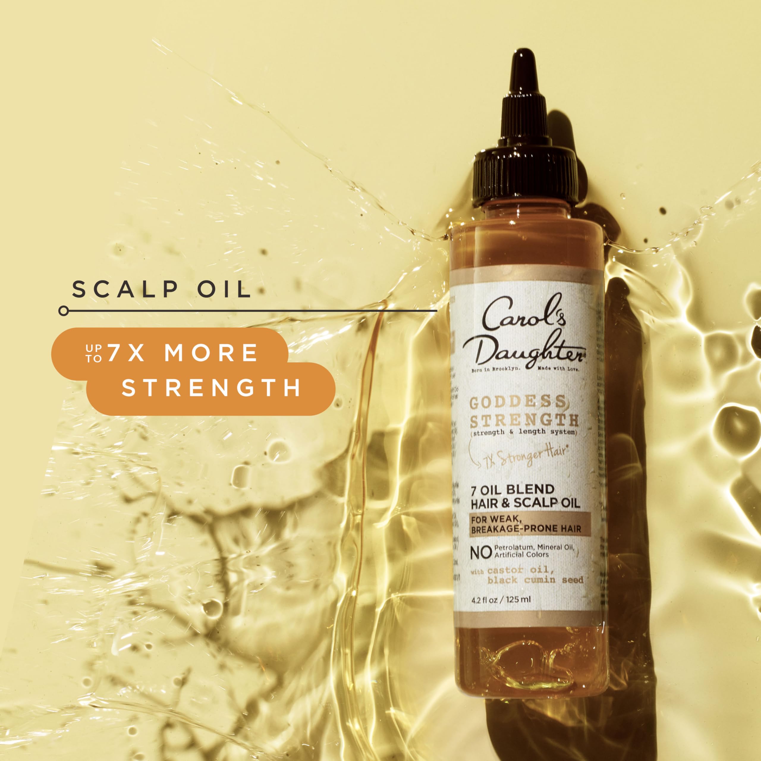 Carol's Daughter applying oil to scalp to relieve dryness and nourish