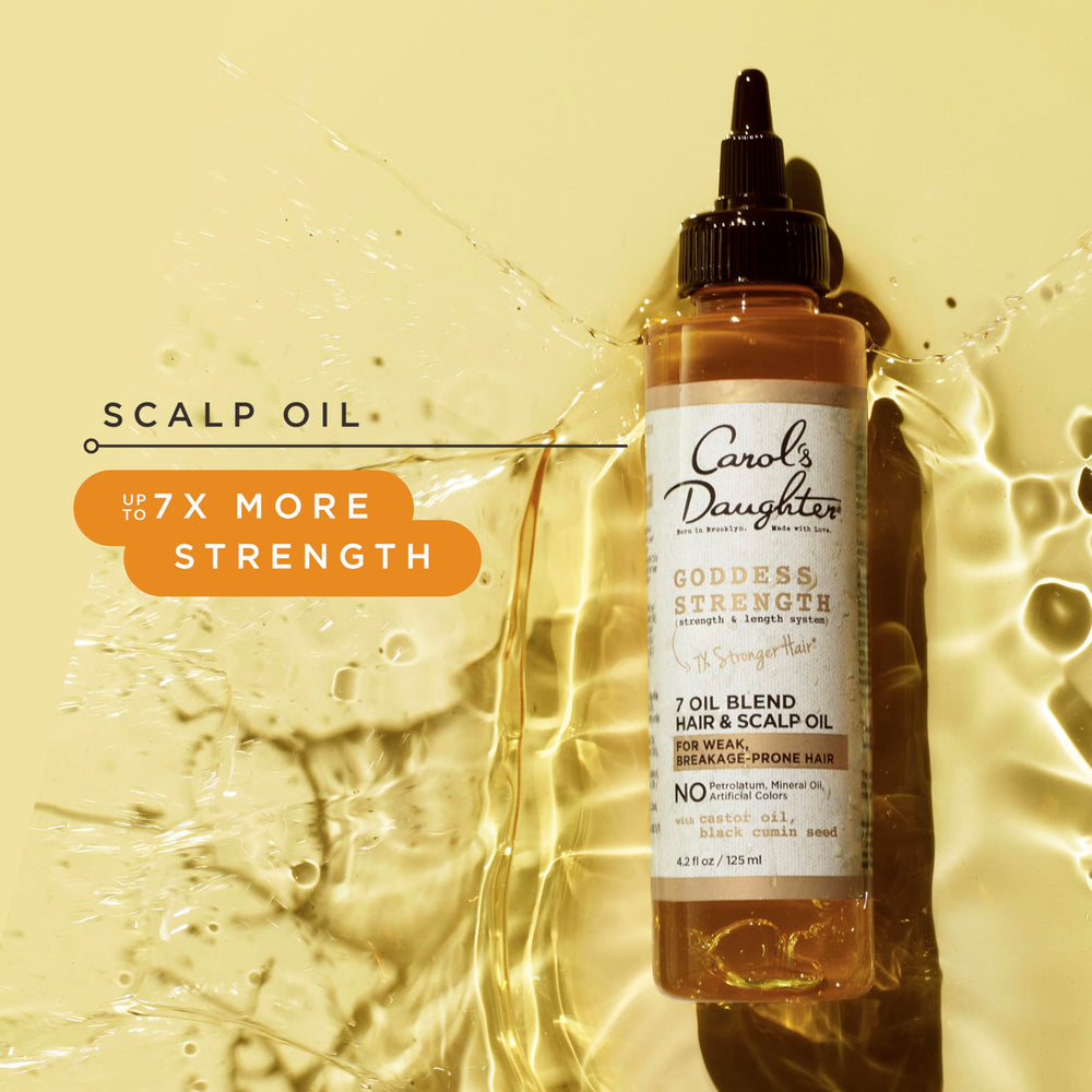 Carol's Daughter applying oil to scalp to relieve dryness and nourish