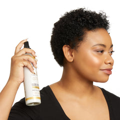 Carol's Daughter bottle paired with castor oil, black cumin seed and ginger