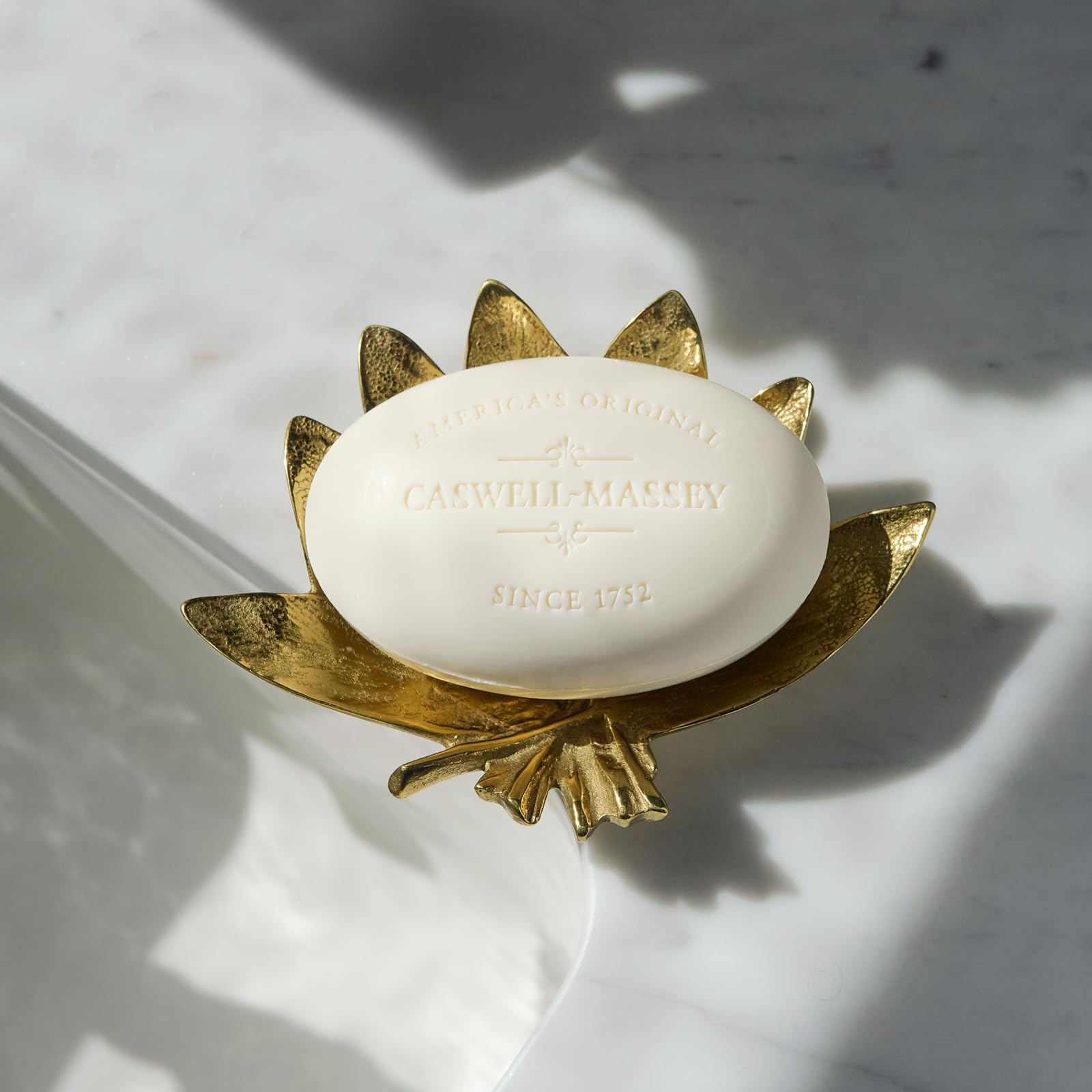 Natural ingredients next to Caswell-Massey almond soap highlighting plant-based formula