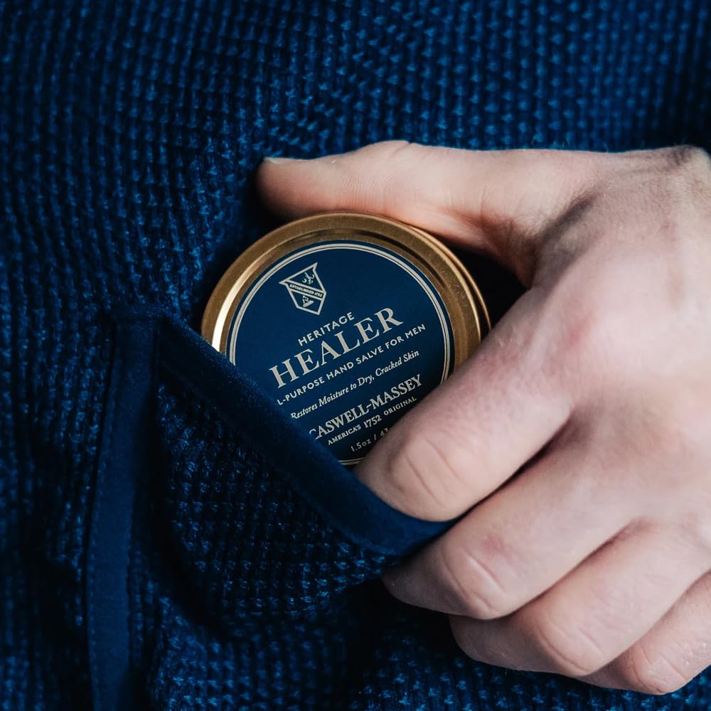 Caswell-Massey 1.5 oz tin next to a keys and phone demonstrating compact travel-friendly size