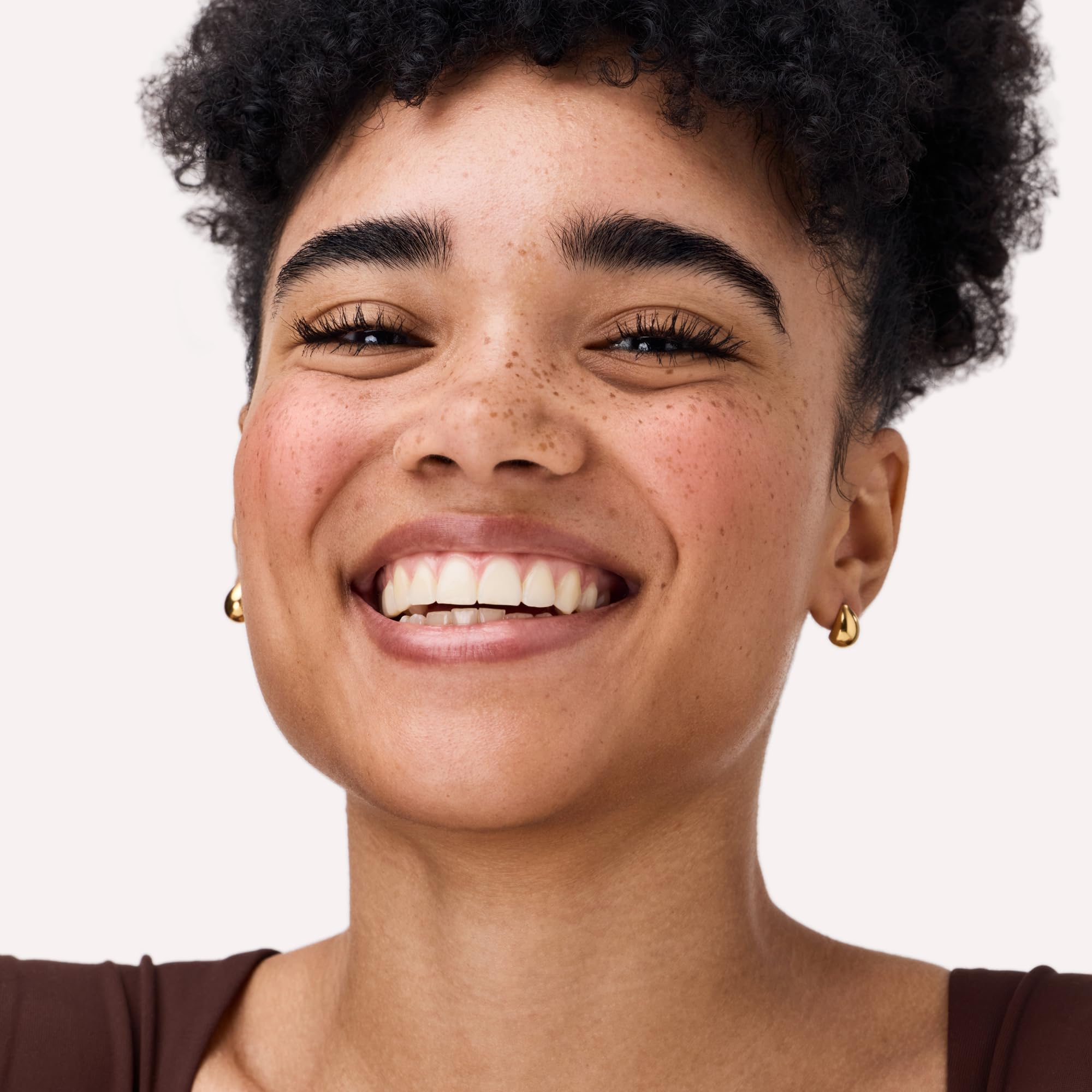Catrice blush applied to model cheeks giving natural lifted glow and warmth