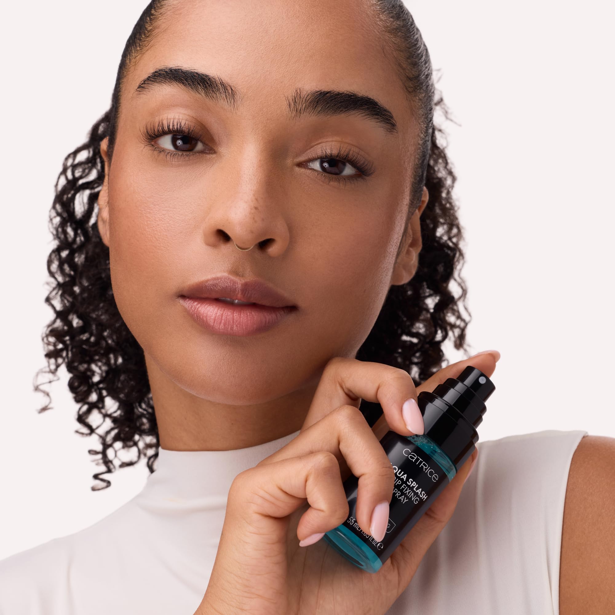 Catrice Cosmetics spray applied over finished makeup to extend wear and refresh