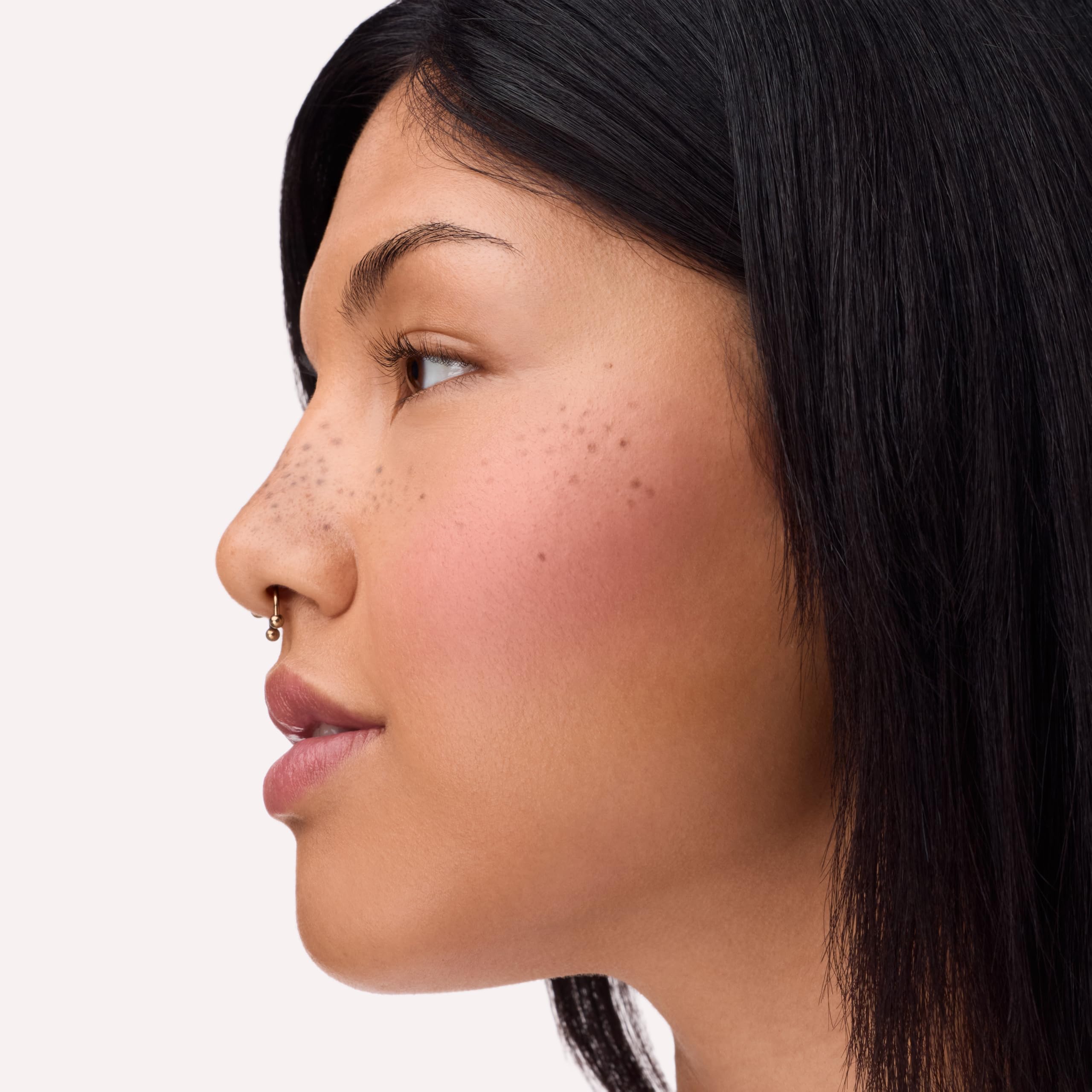 Catrice blended blush on cheeks in mirror for natural, soft-focus finish