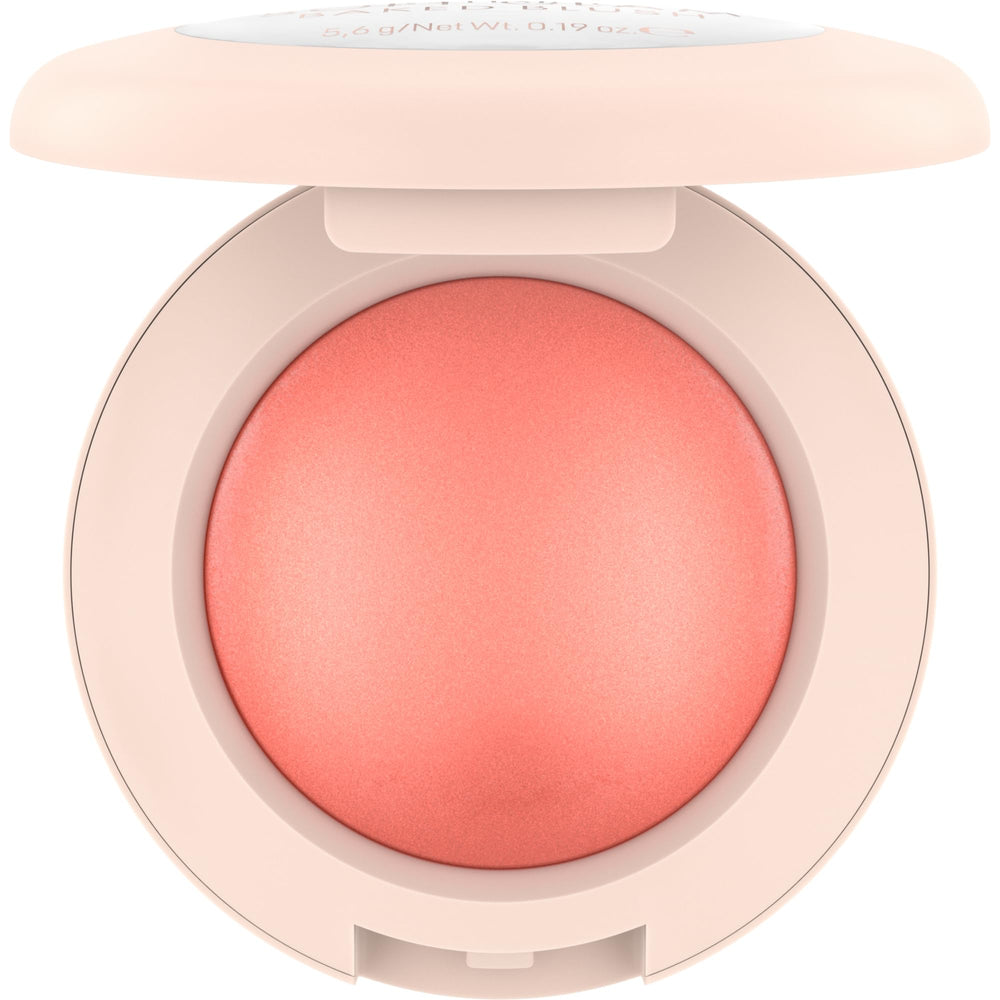 Catrice swatch of Cheeky Coral on skin illustrating buildable, luminous color