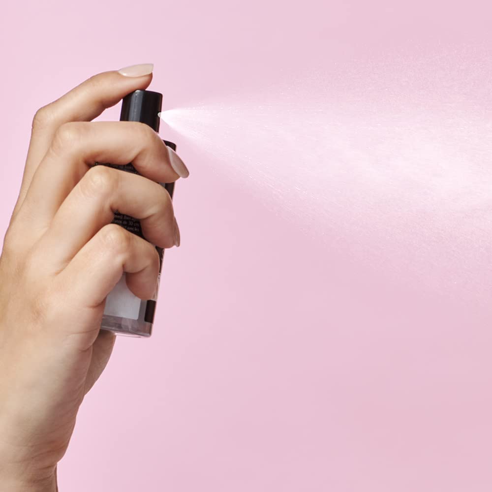Catrice model applying spray to set makeup for long-lasting wear
