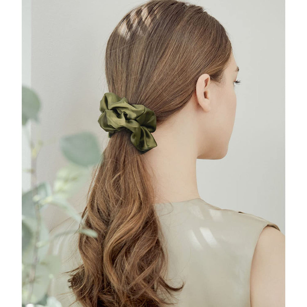 Cehomi scrunchie next to ruler showing size and stretch for most hair types