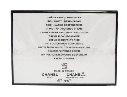 CHANEL N°5 cream close-up texture on fingertip highlighting rich moisturizing feel