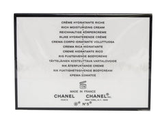 CHANEL N°5 cream close-up texture on fingertip highlighting rich moisturizing feel