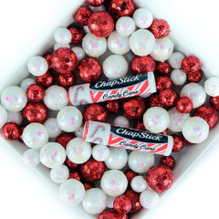 Hand holding ChapStick Candy Cane tube ready for quick touch-ups