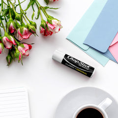 Applying ChapStick classic in hand to show quick lip moisture boost