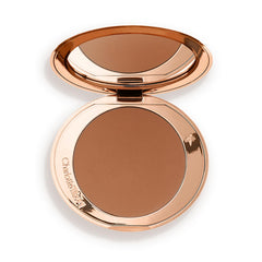 Charlotte Tilbury compact front view showing sleek case and bronzer for travel