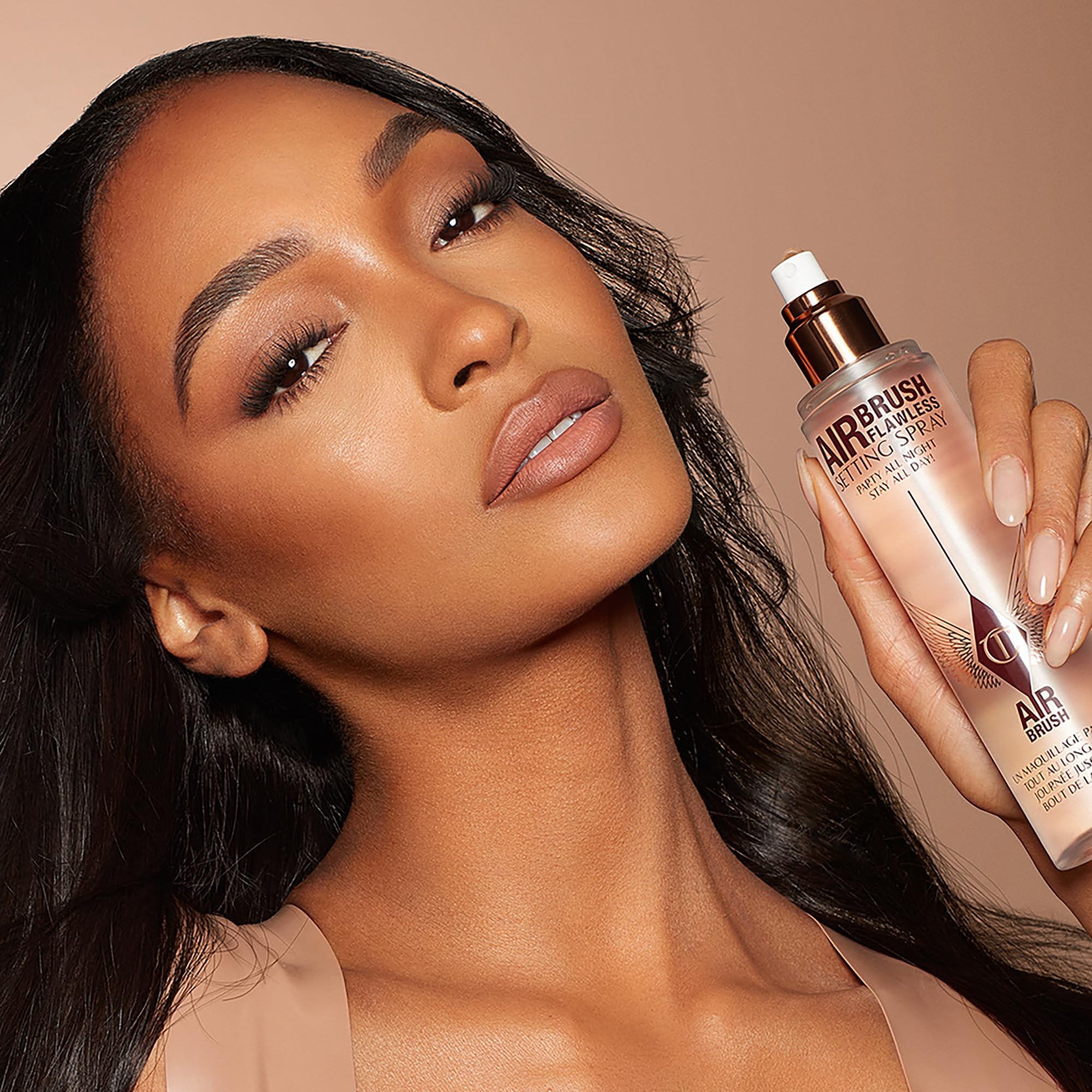 Charlotte Tilbury in a purse lifestyle scene for on-the-go refreshing and touch-ups