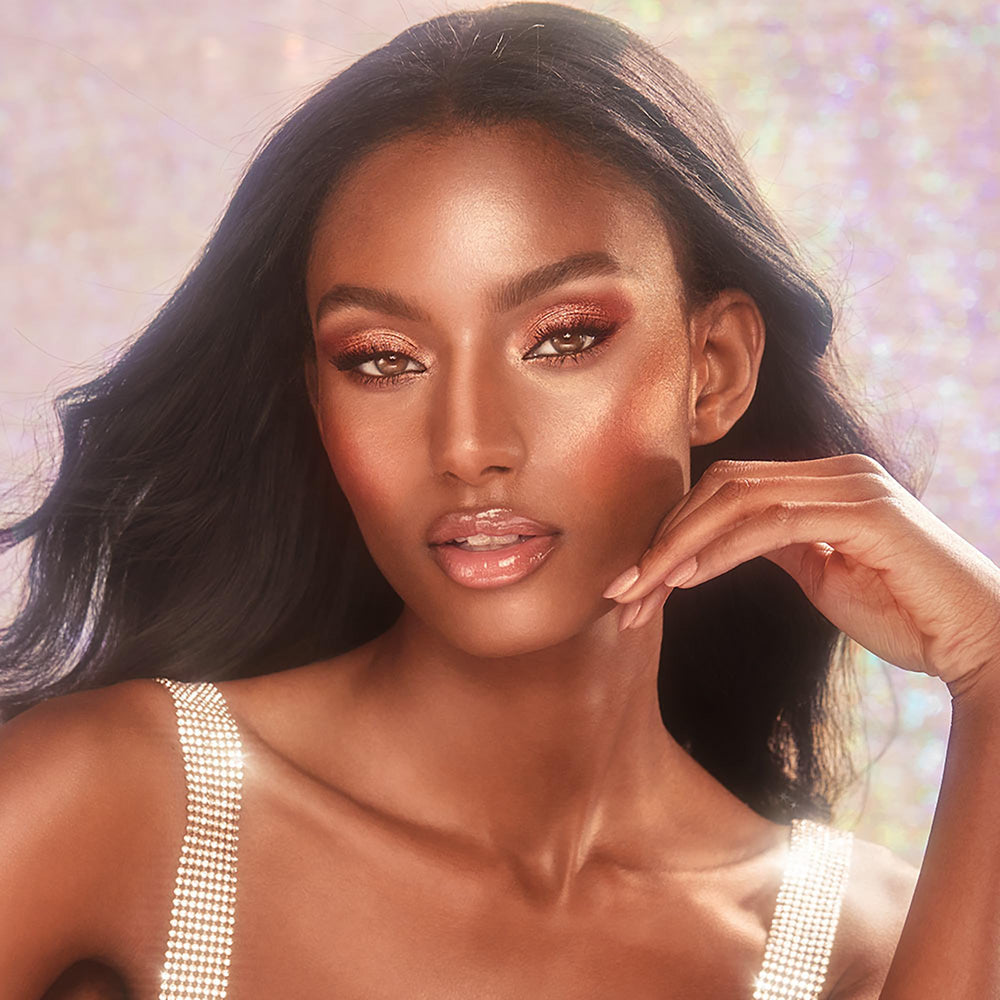 Charlotte Tilbury gloss heart-shaped applicator close-up for precise, cushioned application benefit