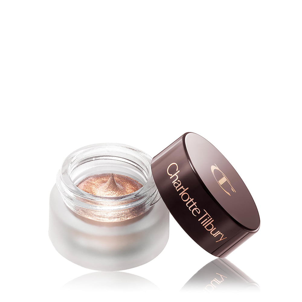 Charlotte Tilbury pot placed on vanity with brush suggesting effortless everyday glam
