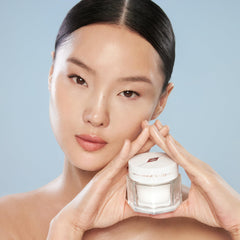 Charlotte Tilbury on vanity lifestyle scene showing glass-skin finish and makeup base
