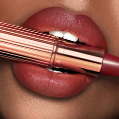 Charlotte Tilbury lipstick applied on lips showing smooth natural berry finish