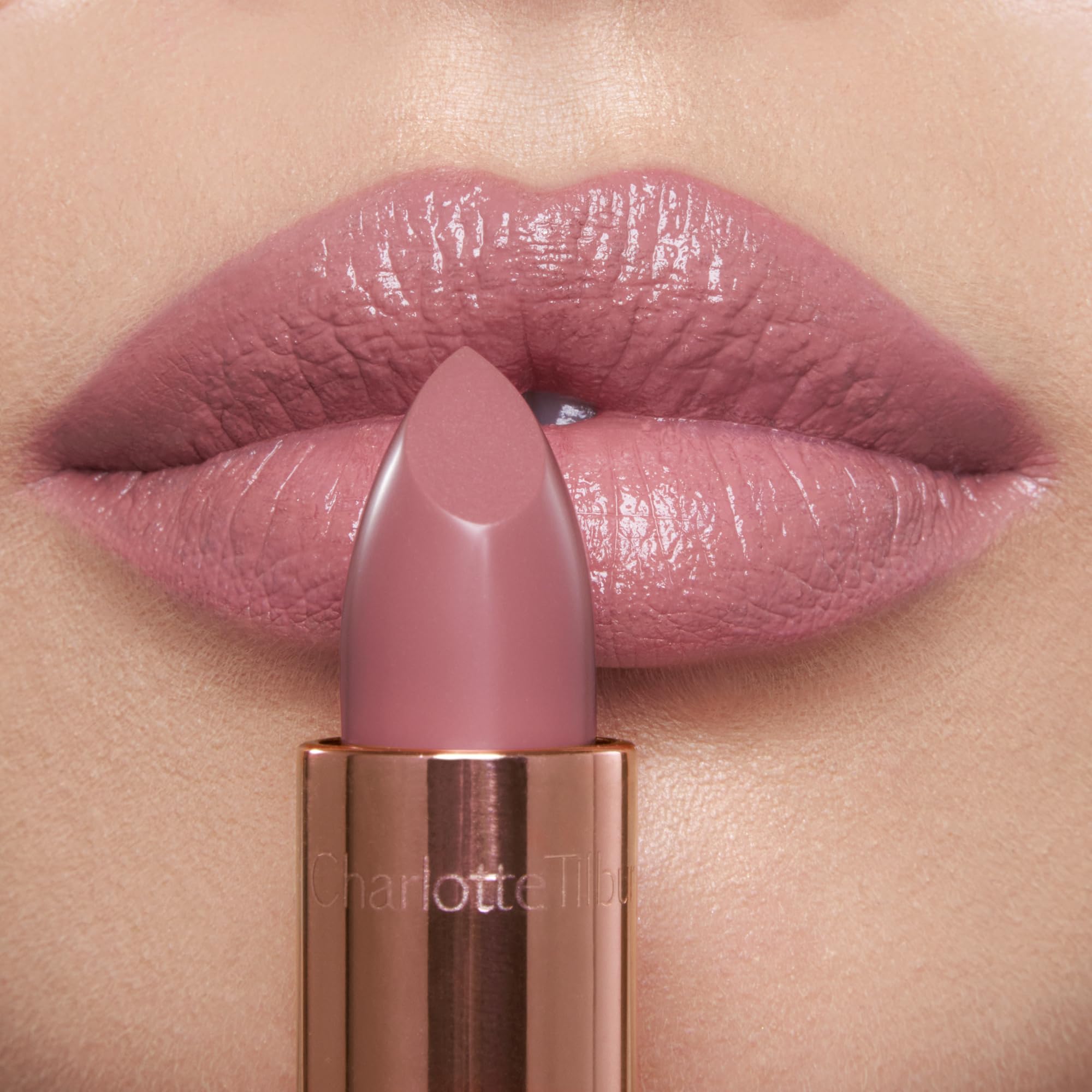 Charlotte Tilbury lipstick applied on lips showing cool-toned pink benefit: luminous, fuller-looking pout
